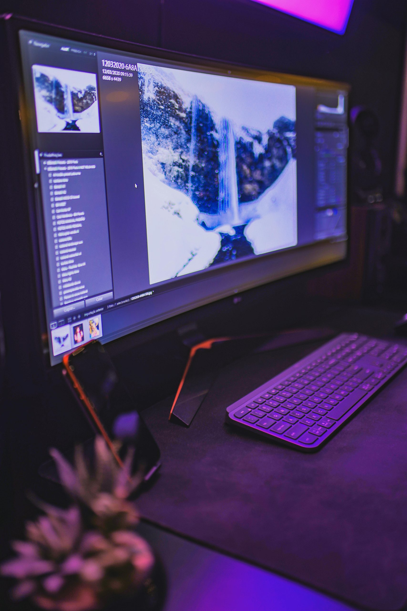 Ultrawide monitor setup with a sleek keyboard, ideal for productivity and technology enthusiasts.